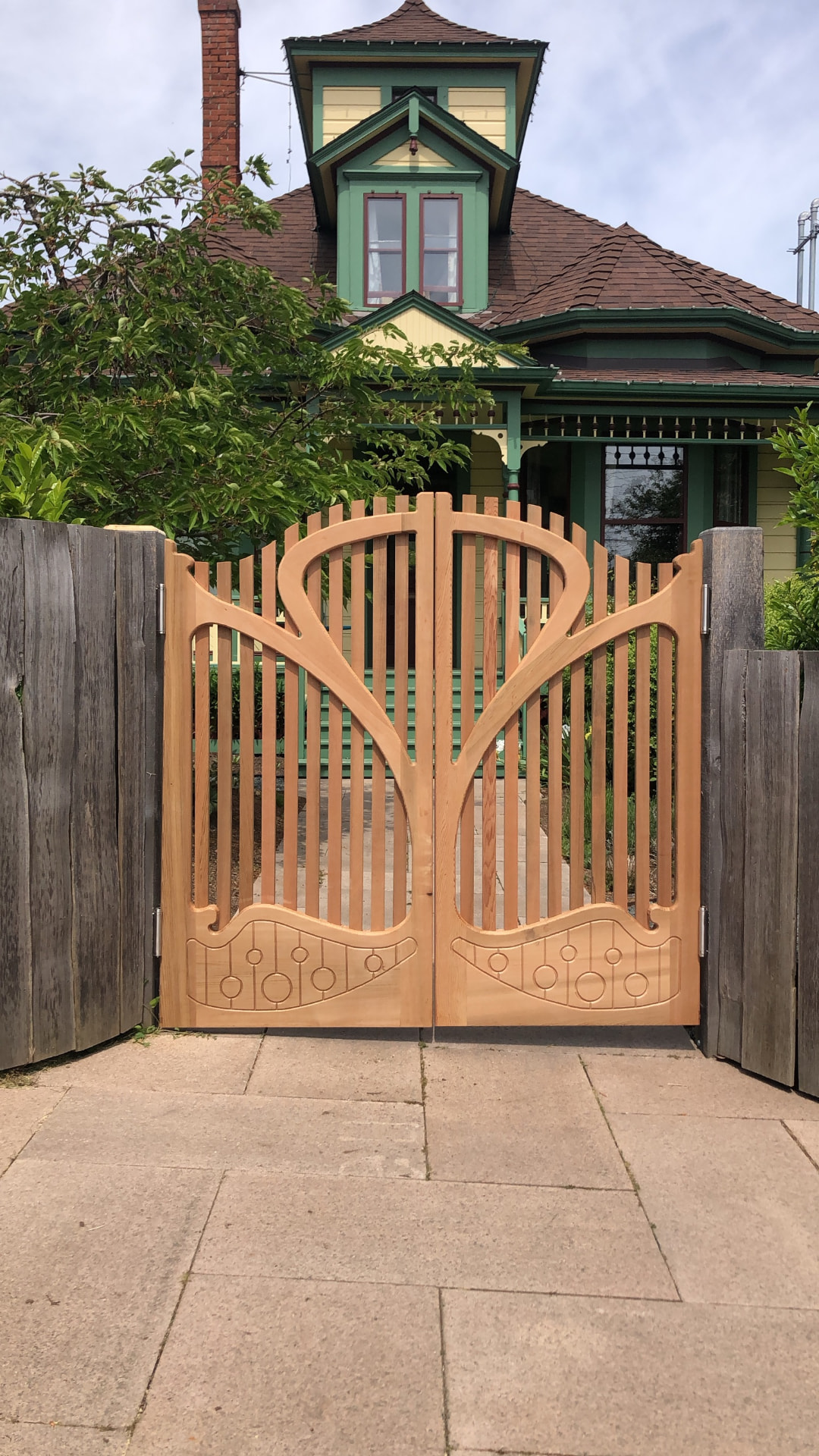 Art nouveau cedar garden gate with carved sweeping curves